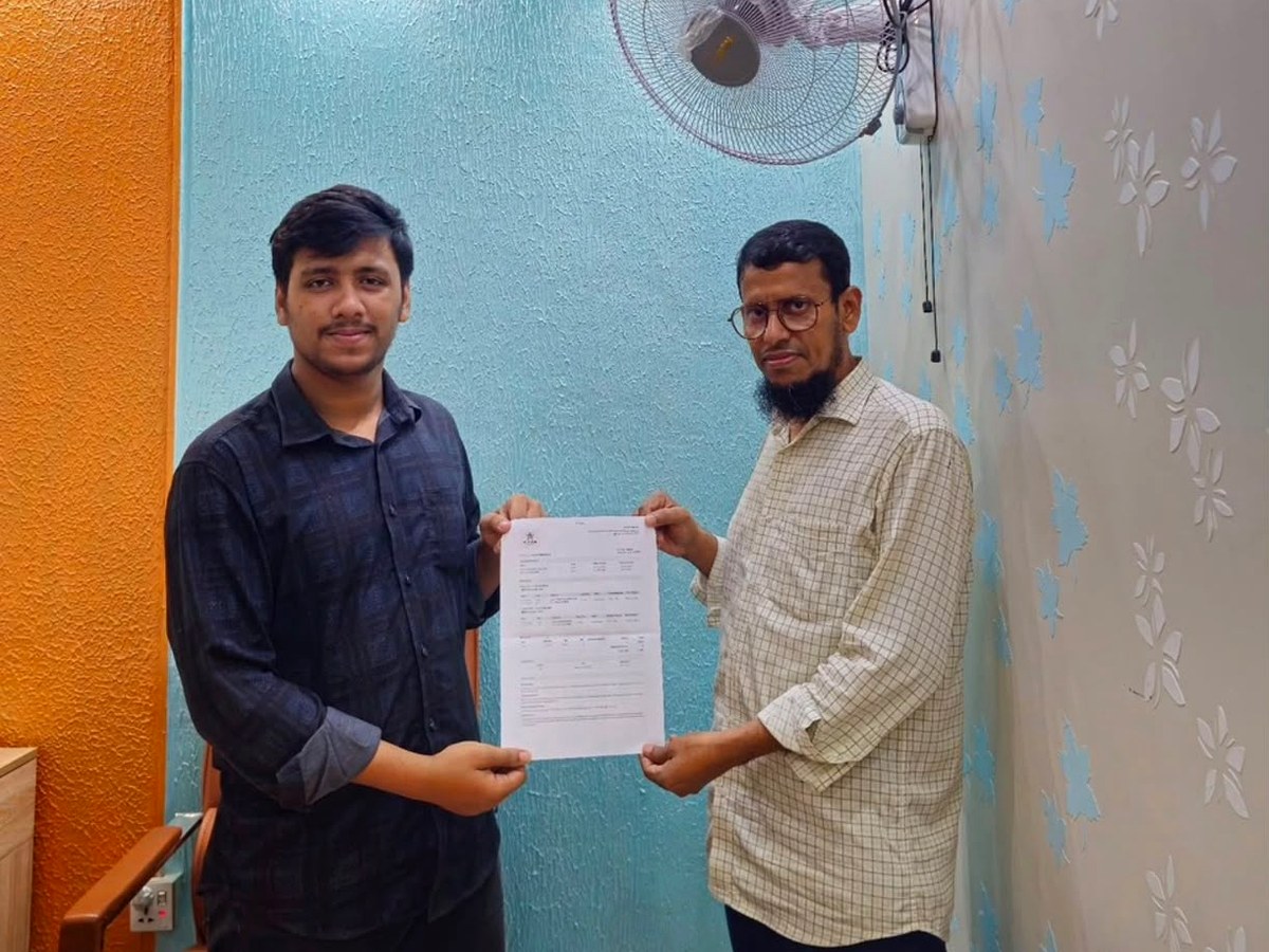 Customer collecting travel documents at New Star Travels
